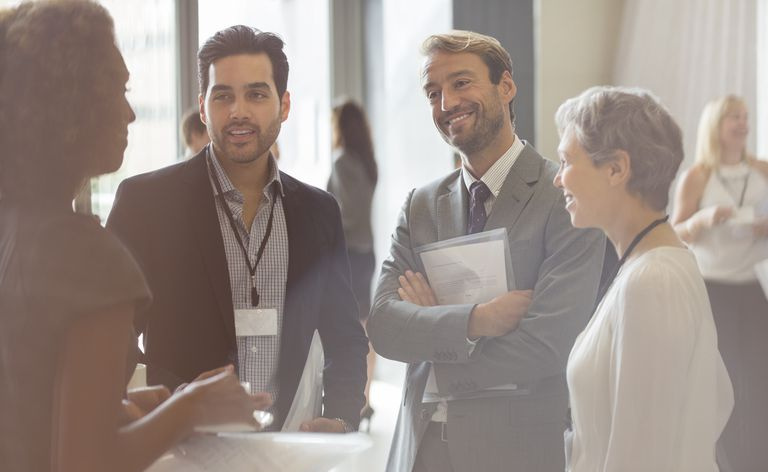 Grupo de empresarios sonriendo y discutiendo en la oficina