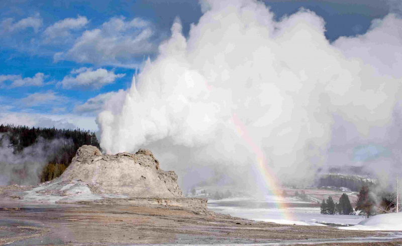 Wybuch gejzeru zamkowego z tęczą w Parku Narodowym Yellowstone