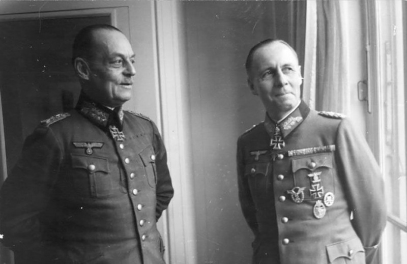 Gerd von Rundstedt a Erwin Rommel v nemeckých vojenských uniformách stojaci pri okne.