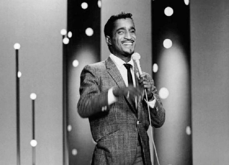 Schwarz-Weiß-Foto von Sammy Davis, Jr., der auf der Bühne auftritt.