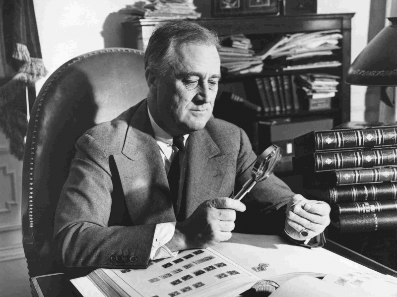 Prezydent Franklin Roosevelt patrzy na znaczek przez lupę