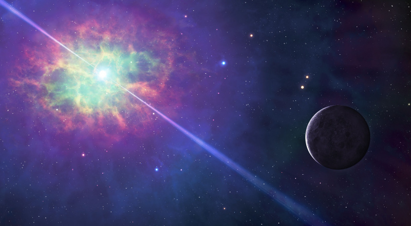 Imagen del espacio, con una nube de colores que rodea una estrella que proyecta haces de luz en dos direcciones, con un planeta iluminado cerca.