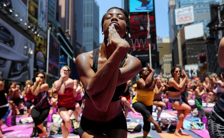 Menschen, die im multikulturellen New York Yoga praktizieren, das lose auf buddhistischen Lehren basiert