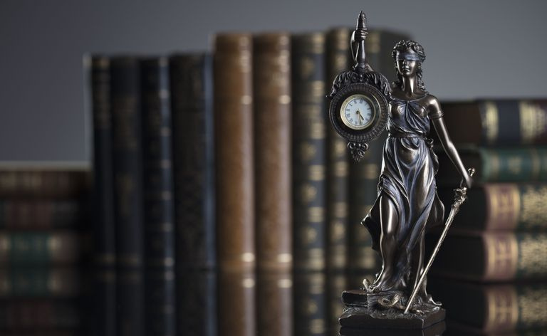 Estatua de Themis y libros legales.