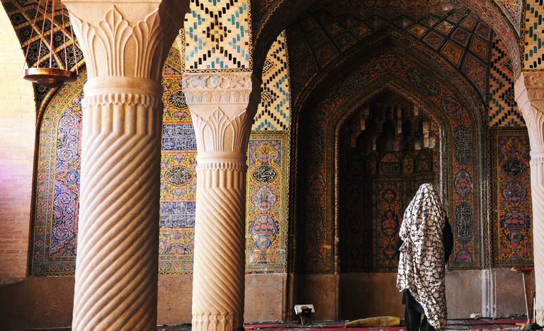 Columnas muy ornamentales con flautas en espiral, mosaicos con incrustaciones en un salón con la espalda de una persona de pie