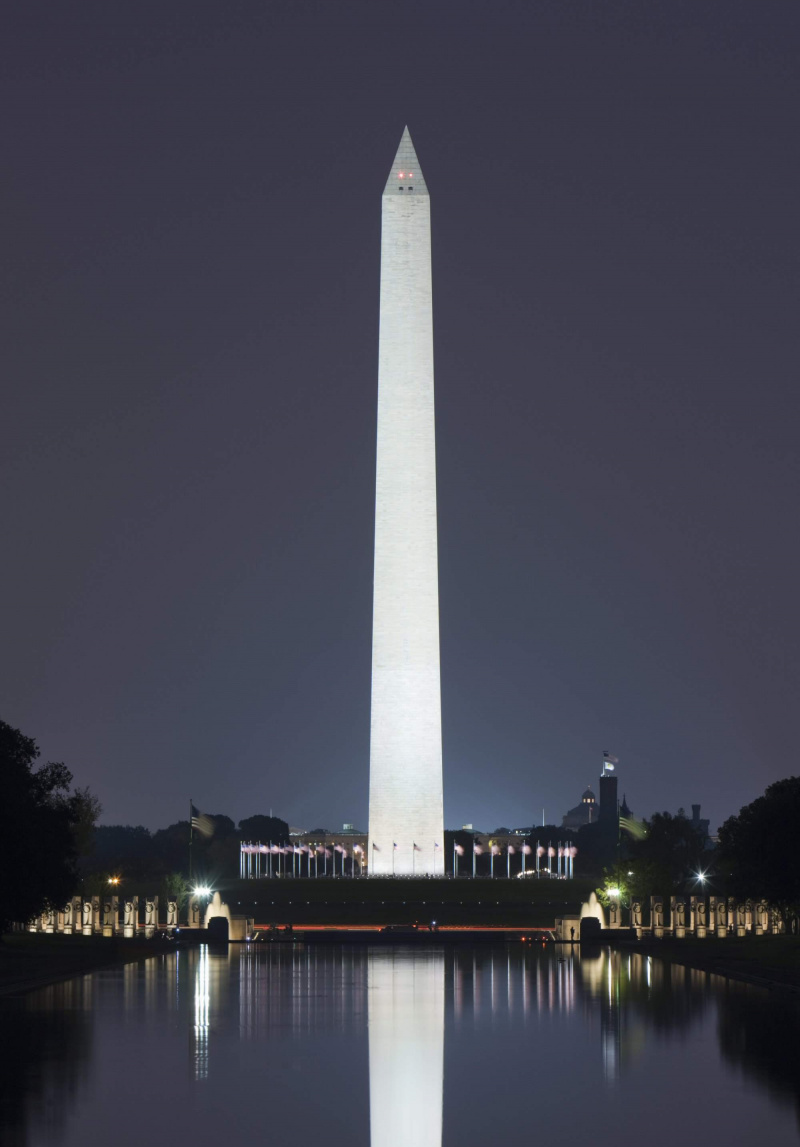 Das nachts beleuchtete Washington Monument spiegelt sich im Reflecting Pool wider